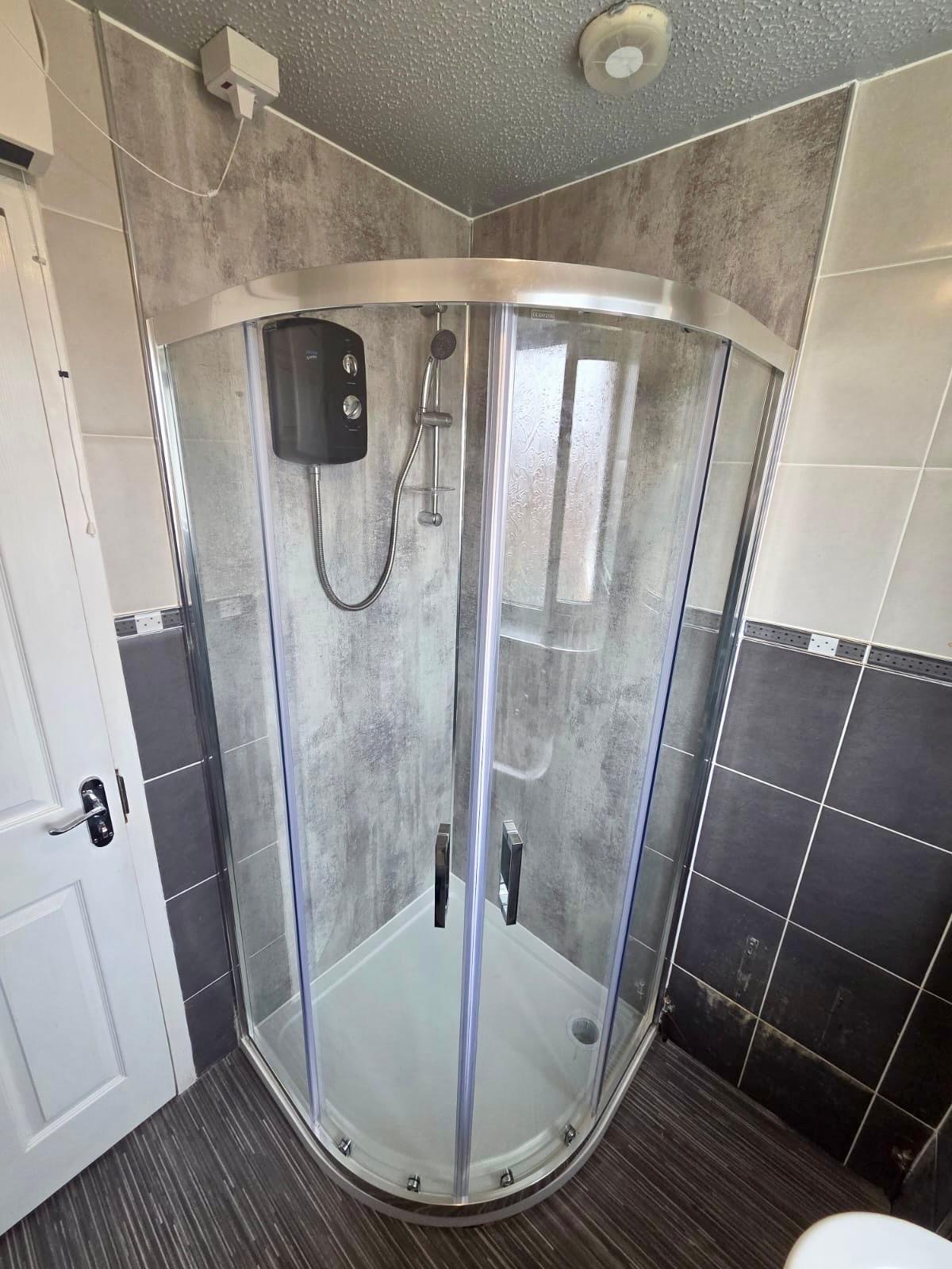 Completed curved shower enclosure