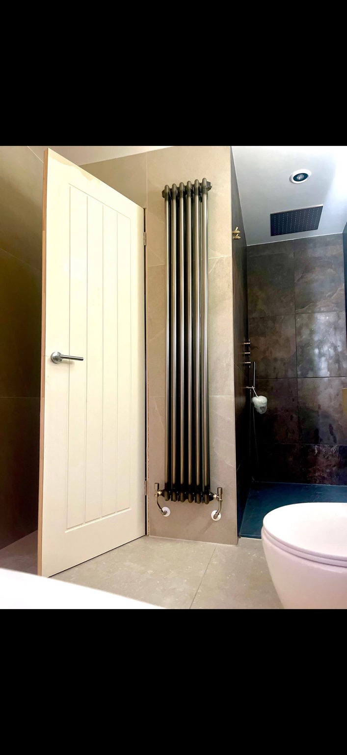 Tall column radiator installed in a bathroom